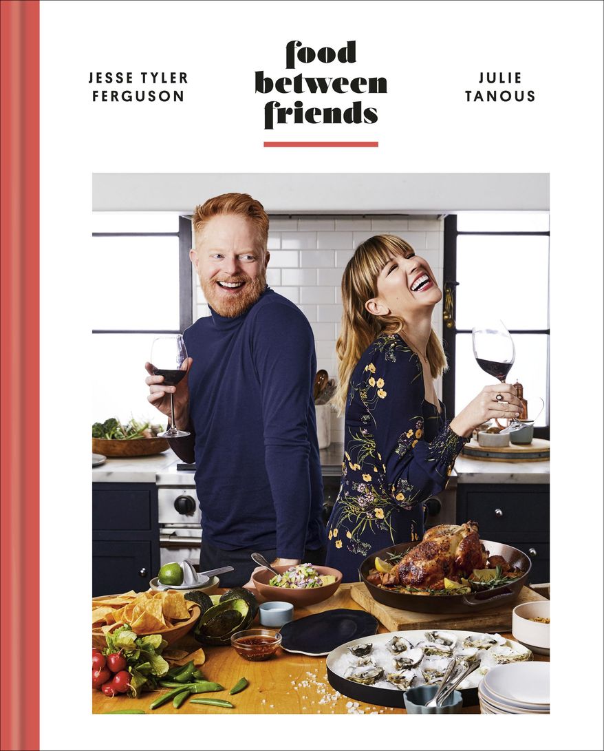 This cover image shows &amp;quot;Food Between Friends&amp;quot; by Jesse Tyler Ferguson and Julie Tanous. (Clarkson Potter via AP)