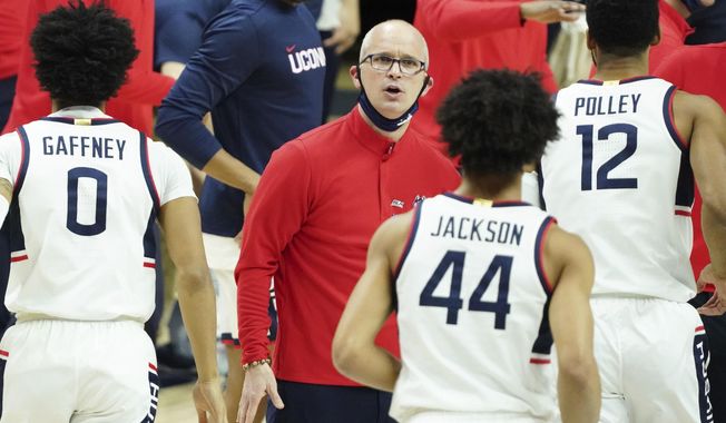 Connecticut head coach Dan Hurley greets his players a break against Georgetown in the first half of an NCAA college basketball game Saturday, March 6, 2021, in Storrs, Conn. (David Butler II/Pool Photo via AP)