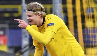 Dortmund&#39;s Erling Haaland celebrates after scoring his sides first goal during the Champions League, round of 16, second leg soccer match between Borussia Dortmund and Sevilla FC in Dortmund, Germany, Tuesday, March 9, 2021. (Bernd Thissen/Pool via AP)