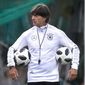 FILE - In this June 14, 2018 file photo, Coach of German national soccer team Joachim Loew carries two balls during a training session at the 2018 soccer World Cup in Vatutinki near Moscow, Russia. (AP Photo/Michael Probst,File)