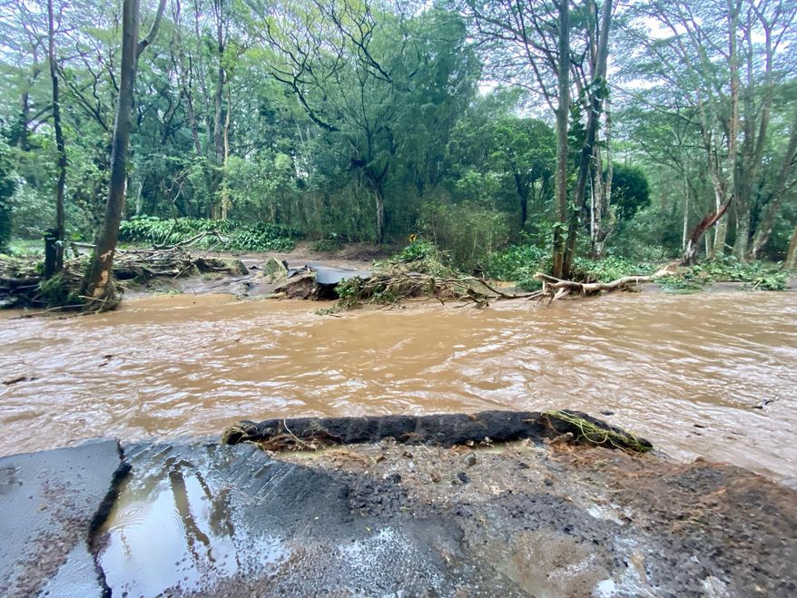 A bridge off Peahi Road is overcome by floodwaters above the Kaupakalua Reservoir and Dam after heavy rainfall on Monday in Haiku, Maui, Hawaii, on Monday, March 8, 2021. Heavy rains caused a dam to overflow on the Hawaiian island of Maui, and and nearby residents in the community of Haiku are being evacuated, county officials said Monday.(Kehaulani Cerizo/The Maui News via AP)