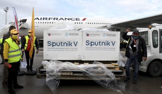 Boxes loaded with the Russian Sputnik V COVID-19 vaccine arrive at Tunis airport, Tuesday, March 9, 2021. Tunisia is also awaiting the arrival of the first lot of the Chinese vaccine Sinovac as well as the Pfizer and Astrozeneca vaccines (AP Photo/Hassene Dridi)