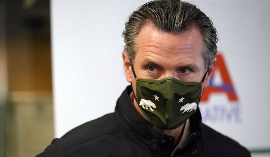 California Gov. Gavin Newsom wears a mask during a visit to a vaccination center Wednesday, March 10, 2021, in South Gate, Calif. (AP Photo/Marcio Jose Sanchez)