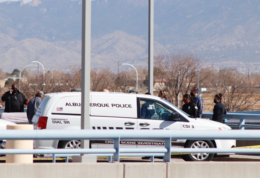 Police investigate where four bodies were found last Friday March 5, on the upper level of the parking garage at the Albuquerque International Sunport airport, Wednesday, March 10, 2021, in Albuquerque, N.M. A man sought in the killings of four people in New Mexico and one in New Jersey was arrested Wednesday morning in St. Louis, the U.S. Marshals Service said. (Matthew Reisen/The Albuquerque Journal via AP)