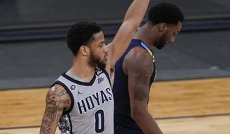Georgetown&#39;s Jahvon Blair, left, gestures as Marquette&#39;s Symir Torrence, right, leaves the court after an NCAA college basketball game in the Big East conference tournament Wednesday, March 10, 2021, in New York. Georgetown won 68-49. (AP Photo/Frank Franklin II)