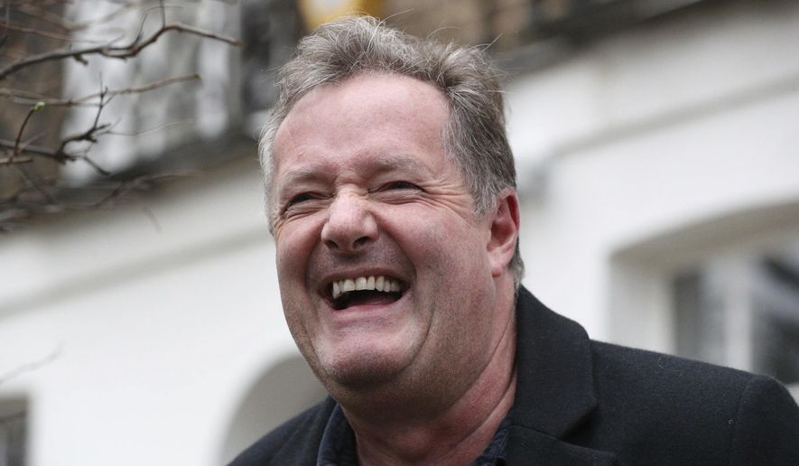 British television host Piers Morgan laughs as he speaks to reporters outside his home in Kensington, central London, Wednesday March 10, 2021. Morgan quit the “Good Morning Britain” program on Tuesday after making controversial comments about the Duchess of Sussex. The U.K.’s media watchdog said earlier Tuesday it was launching an investigation into the show under its harm and offense rules after receiving more than 41,000 complaints about Morgan’s comments on Meghan. (Jonathan Brady/PA via AP)