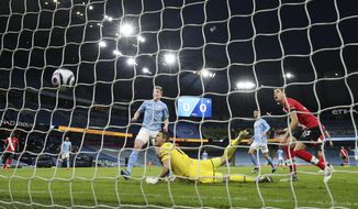 Manchester City&#x27;s Kevin De Bruyne, left, scores his side&#x27;s opening goal during the English Premier League soccer match between Manchester City and Southampton at the Etihad Stadium in Manchester, England, Wednesday, March 10, 2021. (Clive Brunskill/Pool via AP)
