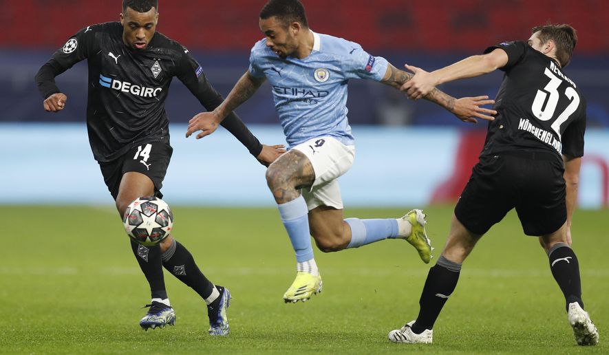 Manchester City's Gabriel Jesus, center, is challenged by Moenchengladbach's Alassane Plea, left and Moenchengladbach's Florian Neuhaus during the Champions League round of 16 first leg soccer match between Borussia Monchengladbach and Manchester City at the Puskas Arena stadium in Budapest, Hungary, Wednesday, Feb. 24, 2021. (AP Photo/Laszlo Balogh)