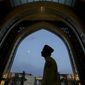 FILE - In this May 16, 2019, file photo, a worshiper arrives at a mosque for Iftar during the holy Islamic month of Ramadan in Kuala Lumpur, Malaysia. A Malaysian court ruled Wednesday, March 10, 2021, that non-Muslims can use the word “Allah” to refer to God, in a major decision in a divisive issue for religious freedom in the Muslim-majority country. (AP Photo/Annice Lyn, File)