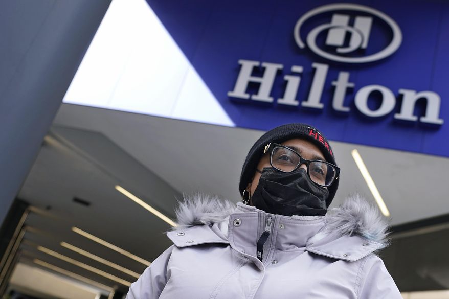 Hotel housekeeper Esther Montanez poses outside the Hilton Back Bay, Friday, March 5, 2021, in Boston. Montanez refuses to give up hope of returning to her cleaning job at the hotel, which she held for six years until being furloughed since March 2020 due to the COVID-19 virus outbreak. (AP Photo/Charles Krupa)