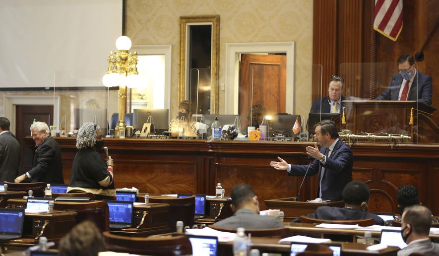 South Carolina Rep. Wendy Brawley, D-Hopkins, left, and Rep. Jay Jordan, R-Florence, right, debate a bill that would have all 46 counties follow the same election rules on Wednesday, March 10, 2021, in Columbia, S.C. The bill passed 84-36 mostly on party lines. (AP Photo/Jeffrey Collins)