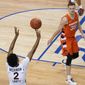 Virginia guard Reece Beekman (2) launches the game winning shot as Syracuse guard Buddy Boeheim (35) watches during the second half of an NCAA college basketball game in the quarterfinal round of the Atlantic Coast Conference tournament in Greensboro, N.C., Thursday, March 11, 2021. Virginia won the game 72-69. (AP Photo/Gerry Broome)