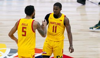 Maryland guard Darryl Morsell (11) and guard Eric Ayala (5) celebrates in the first half of an NCAA college basketball game against Michigan State at the Big Ten Conference tournament in Indianapolis, Thursday, March 11, 2021. (AP Photo/Michael Conroy)