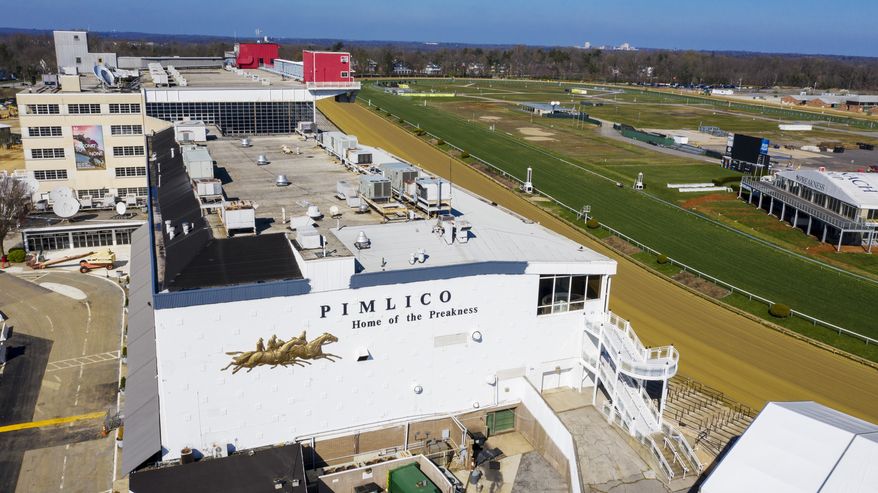 In this March 26, 2020, file photo, tractors groom the racing surface at the Pimlico Race Track in Baltimore, Md. Sports betting would be allowed online, at Maryland&#39;s six casinos and the stadiums where the state&#39;s three major professional sports teams play, as well as horse racing tracks, under a measure approved Thursday, March 11, 2021, by the House of Delegates.  (AP Photo/Steve Helber, File) **FILE**