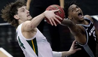 Baylor&#39;s Matthew Mayer, left, blocks a shot by Kansas State&#39;s DaJuan Gordon (3) during the first half of an NCAA college basketball game in the second round of the Big 12 Conference tournament in Kansas City, Mo., Thursday, March 11, 2021. (AP Photo/Charlie Riedel)
