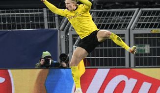Dortmund&#39;s Erling Haaland celebrates after scoring his sides second goal during the Champions League, round of 16, second leg soccer match between Borussia Dortmund and Sevilla FC in Dortmund, Germany, Tuesday, March 9, 2021. (Bernd Thissen/Pool via AP)