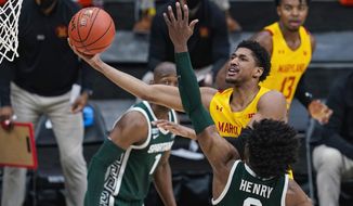 Maryland guard Aaron Wiggins (2) shoots over Michigan State forward Aaron Henry (0) in the second half of an NCAA college basketball game at the Big Ten Conference tournament in Indianapolis, Thursday, March 11, 2021. (AP Photo/Michael Conroy)