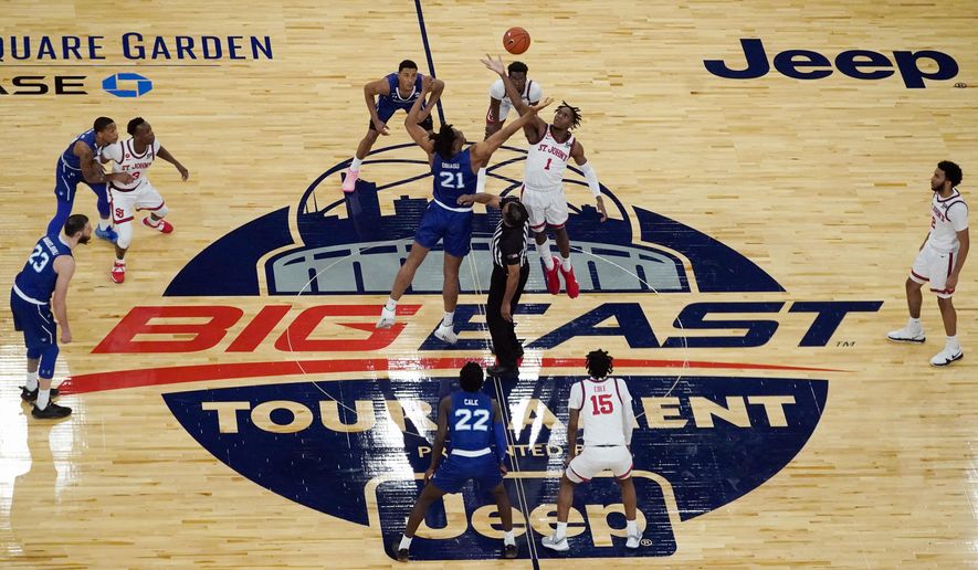 Seton Hall&#x27;s Ike Obiagu (21) and St. John&#x27;s Josh Roberts (1) vie for the opening tip-off in the first half of an NCAA college basketball game in the quarterfinals of the Big East conference tournament, Thursday, March 11, 2021, in New York. (AP Photo/Mary Altaffer)