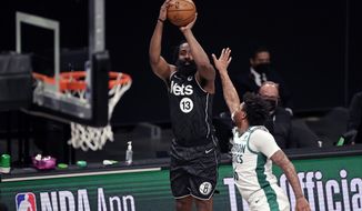 Brooklyn Nets guard James Harden (13) shoots over Boston Celtics guard Marcus Smart during the first half of an NBA basketball game, Thursday, March 11, 2021, in New York. (AP Photo/Adam Hunger)