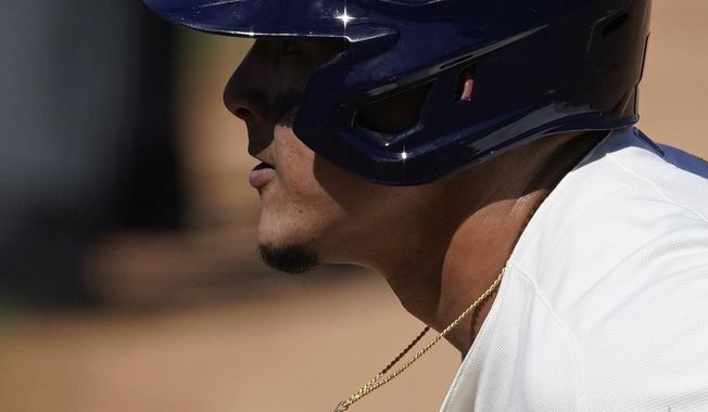 Milwaukee Brewers&#x27; Avisail Garcia leads off from first base during the fourth inning of a spring training baseball game against the Chicago Cubs Saturday, March 6, 2021, in Phoenix. (AP Photo/Ashley Landis)