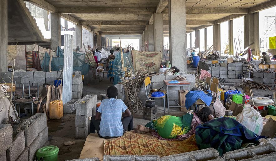 People displaced by the recent conflict live in crowded conditions at a makeshift camp for the displaced in a derelict building of the Shire campus of Axum University, in Shire, in the Tigray region of northern Ethiopia Tuesday, Feb. 23, 2021. (International Rescue Committee via AP)
