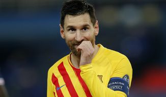Barcelona&#39;s Lionel Messi reacts after a missed a penalty shot during the Champions League, round of 16, second leg soccer match between Paris Saint-Germain and FC Barcelona at the Parc des Princes stadium in Paris, Wednesday, March 10, 2021. (AP Photo/Christophe Ena)