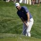 Dustin Johnson chips to the green on the ninth hole during the first round of the The Players Championship golf tournament Thursday, March 11, 2021, in Ponte Vedra Beach, Fla. (AP Photo/John Raoux) **FILE**