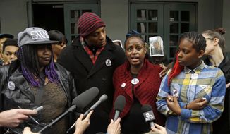 FILE - In this March 22, 2017, file photo, Venus Hayes, second from right, Hayes, the mother the 17-year-old Quanice Hayes, is surrounded by family members as she speaks during a press conference in Portland, Ore. City commissioners apologized Wednesday, March 10, 2021, to the family of a teenager who was shot and killed by Portland police, before approving a $2.1 million settlement of the family&#x27;s federal wrongful death lawsuit. The Oregonian/OregonLive reports Quanice Hayes’ grandmother and two uncles said they remain disturbed that Officer Andrew Hearst still works for the Police Bureau and faced no discipline. (AP Photo/Don Ryan, File)