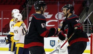 Carolina Hurricanes&#x27; Morgan Geekie (67) is congratulated by Nino Niederreiter (21) after his second goal of the night, during the second period of the team&#x27;s NHL hockey game against the Nashville Predators in Raleigh, N.C., Thursday, March 11, 2021. (AP Photo/Karl B DeBlaker)