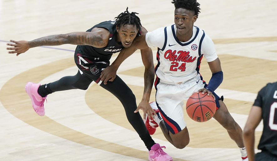 Mississippi's Jarkel Joiner (24) moves past South Carolina's T.J. Moss in the first half of an NCAA college basketball game in the Southeastern Conference Tournament Thursday, March 11, 2021, in Nashville, Tenn. (AP Photo/Mark Humphrey)