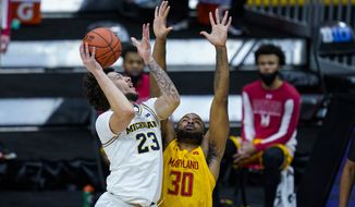 Michigan forward Brandon Johns Jr. (23) shoots over Maryland forward Galin Smith (30) in the first half of an NCAA college basketball game at the Big Ten Conference tournament in Indianapolis, Friday, March 12, 2021. (AP Photo/Michael Conroy)