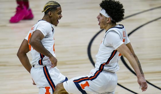 Illinois&#39; Adam Miller, left, and Andre Curbelo celebrate during the second half of the team&#39;s NCAA college basketball game against Rutgers at the Big Ten Conference men&#39;s tournament in Indianapolis, Friday, March 12, 2021. (AP Photo/Michael Conroy)