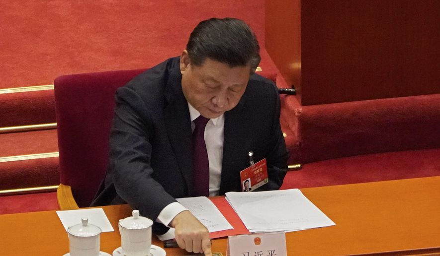 In this Thursday, March 11, 2021, file photo, president Xi Jinping casts his vote during the closing session of the National People&#39;s Congress (NPC) at the Great Hall of the People in Beijing.  (AP Photo/Sam McNeil, File)  **FILE**