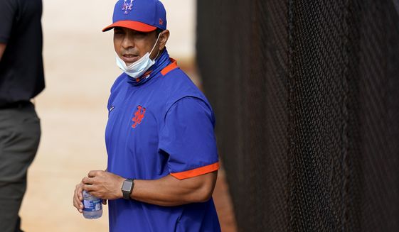 New York Mets manager Luis Rojas watches during spring training baseball practice Tuesday, Feb. 23, 2021, in Port St. Lucie, Fla. (AP Photo/Jeff Roberson)