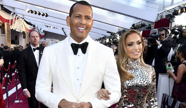 FILE - In this Sunday, Feb. 24, 2019, file photo, Alex Rodriguez, left, and Jennifer Lopez arrive at the Oscars at the Dolby Theatre in Los Angeles. Multiple reports based on anonymous sources say Lopez and Rodriguez called off their two-year engagement. The former New York Yankees shortstop proposed to the actor a couple years ago after the celebrity couple started dating in early 2017. (Photo by Charles Sykes/Invision/AP, File)