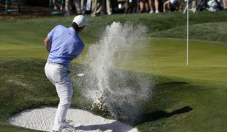 Rory McIlroy, of Northern Ireland, hits from the bunker on the ninth hole during the second round of the The Players Championship golf tournament Friday, March 12, 2021, in Ponte Vedra Beach, Fla. (AP Photo/John Raoux)