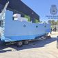 In this photo provided by the Spanish National police on Friday March 12, 2021, a homemade semi submersible submarine sits outside a warehouse in Malaga, Spain. Spanish police say they have seized a homemade narco-submarine able to carry up to 2 metric tons (2.2 tons) of cargo. Police came across the 9-meter-long (30-feet-long) craft being built in Málaga, on southern Spain’s Costa del Sol, during a broader international drug operation. Police said Friday it has two 200-horsepower engines, which are operated from the inside. (Police Nacional via AP)