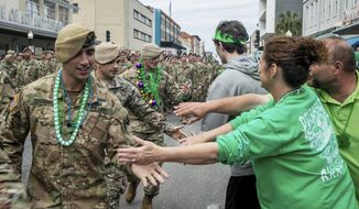 FILE - In this March 16, 2019 file photo, U.S. Army Rangers are greeted as they march down Broughton Street in the St. Patrick&#39;s Day parade in Savannah, Ga. The South&#39;s largest St. Patrick&#39;s Day parade is canceled, as is the boozy riverside festival that accompanies it. Regardless, Savannah is preparing for its largest crowds since the yearlong pandemic began — an influx that officials worry could bring a surge in coronavirus infections. (Randy Thompson/Savannah Morning News via AP)