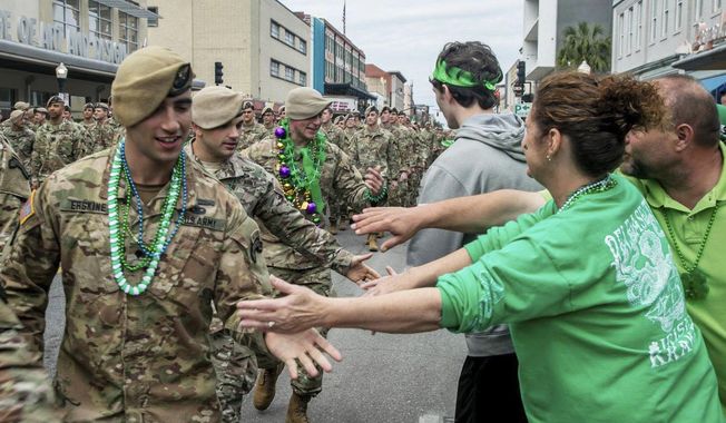 FILE - In this March 16, 2019 file photo, U.S. Army Rangers are greeted as they march down Broughton Street in the St. Patrick&#x27;s Day parade in Savannah, Ga. The South&#x27;s largest St. Patrick&#x27;s Day parade is canceled, as is the boozy riverside festival that accompanies it. Regardless, Savannah is preparing for its largest crowds since the yearlong pandemic began — an influx that officials worry could bring a surge in coronavirus infections. (Randy Thompson/Savannah Morning News via AP)
