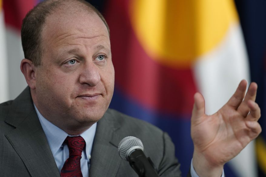 Colorado Governor Jared Polis makes a point during an update on the state&#x27;s efforts to vaccinate residents against the coronavirus during a news conference Tuesday, March 9, 2021, in Denver. (AP Photo/David Zalubowski)