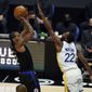 Los Angeles Clippers forward Kawhi Leonard, left, shoots over Golden State Warriors forward Andrew Wiggins (22) during the second half of an NBA basketball game Thursday, March 11, 2021, in Los Angeles. (AP Photo/Marcio Jose Sanchez)