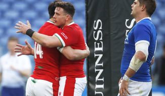 Wales&#39;Louis Rees-Zammit, left, is embraced by teammate Elliot Dee after he scored a try during the Six Nations rugby union match between Italy and Wales, in the Olympic stadium in Rome, Italy, Saturday, March 13, 2021. (AP Photo/Alessandra Tarantino)