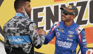 Bubba Wallace, left, congratulates Kyle Larson after Larson won a NASCAR Cup Series auto race Sunday, March 7, 2021, in Las Vegas. (AP Photo/John Locher)