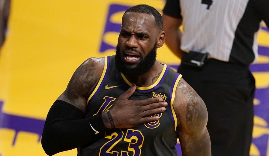 Los Angeles Lakers forward LeBron James reacts after scoring against the Indiana Pacers during the first half of an NBA basketball game Friday, March 12, 2021, in Los Angeles. (AP Photo/Marcio Jose Sanchez)