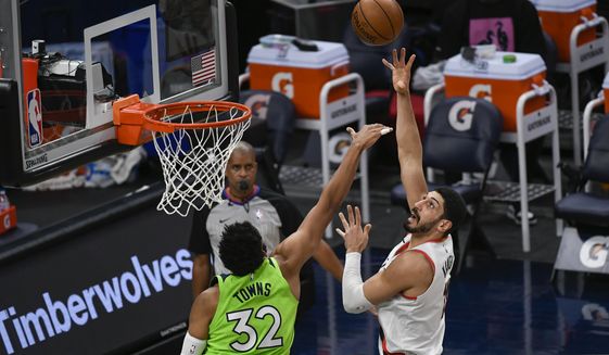 Portland Trail Blazers center Enes Kanter, right, shoots over Minnesota Timberwolves center Karl-Anthony Towns (32) during the first half of an NBA basketball game Saturday, March 13, 2021, in Minneapolis. (AP Photo/Craig Lassig)
