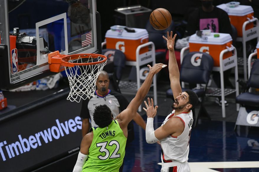 Portland Trail Blazers center Enes Kanter, right, shoots over Minnesota Timberwolves center Karl-Anthony Towns (32) during the first half of an NBA basketball game Saturday, March 13, 2021, in Minneapolis. (AP Photo/Craig Lassig)