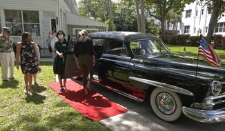 In this Thursday, March 11, 2021, photo provided by the Florida Keys News Bureau, people load into a presidential limousine once used by President Harry S. Truman in front of the Harry S. Truman Little White House Museum in Key West, Fla. A ride in the limo, one of the vehicles that transported Truman during his 1945-1953 presidency, is part of the museum&#39;s recently debuted &amp;quot;White Glove Tour,&amp;quot; providing small groups views of Truman objects not on public display. America&#39;s 33rd president spent nearly six months in Key West spread over 11 visits while in office. (Steve Panariello/Florida Keys News Bureau via AP)
