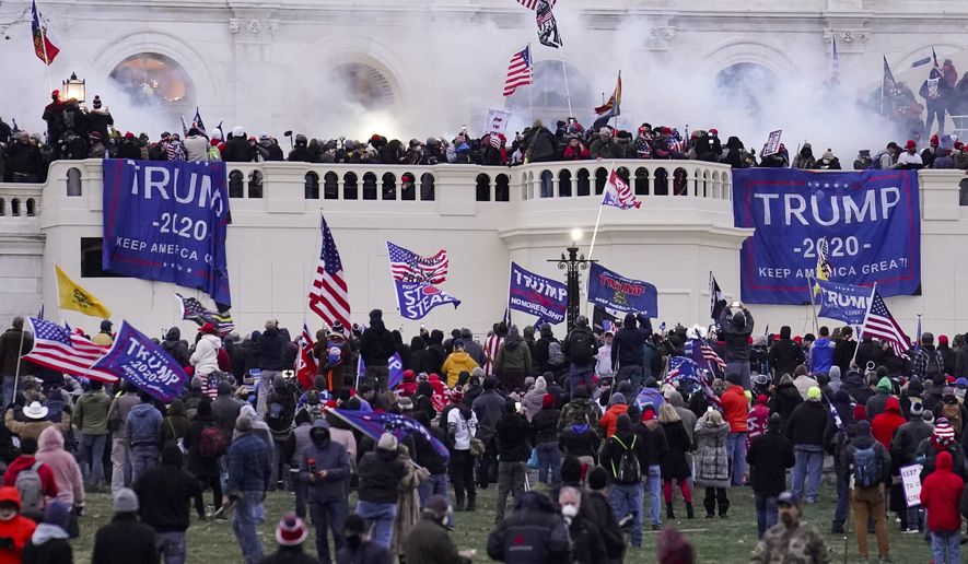 In this Jan. 6, 2021 file photo rioters supporting President Donald Trump storm the Capitol in Washington. (AP Photo/John Minchillo, File)