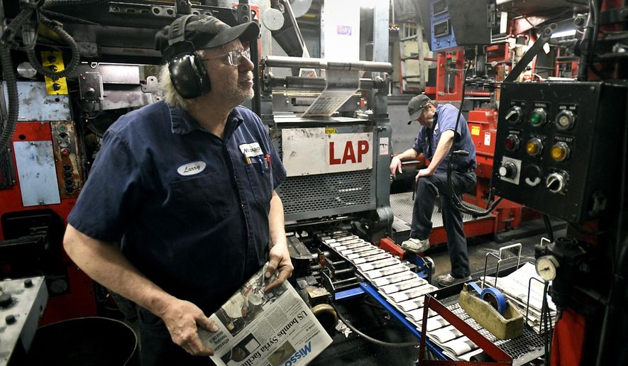 Press operator Larry Sorenson, left, watches the copy counter as he and operator Todd Matthews run the Missoulian press on Feb. 26, 2021 in Missoula, Mont. The press will stop operating at the end of March as printing of the Missoulian moves to the Helena Independent facility in Helena, Mont. (Tom Bauer/The Missoulian via AP)