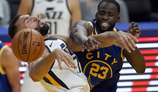 Utah Jazz center Rudy Gobert, left, is fouled by Golden State Warriors forward Draymond Green, right, during the second half of an NBA basketball game in San Francisco, Sunday, March 14, 2021. (AP Photo/Jeff Chiu)